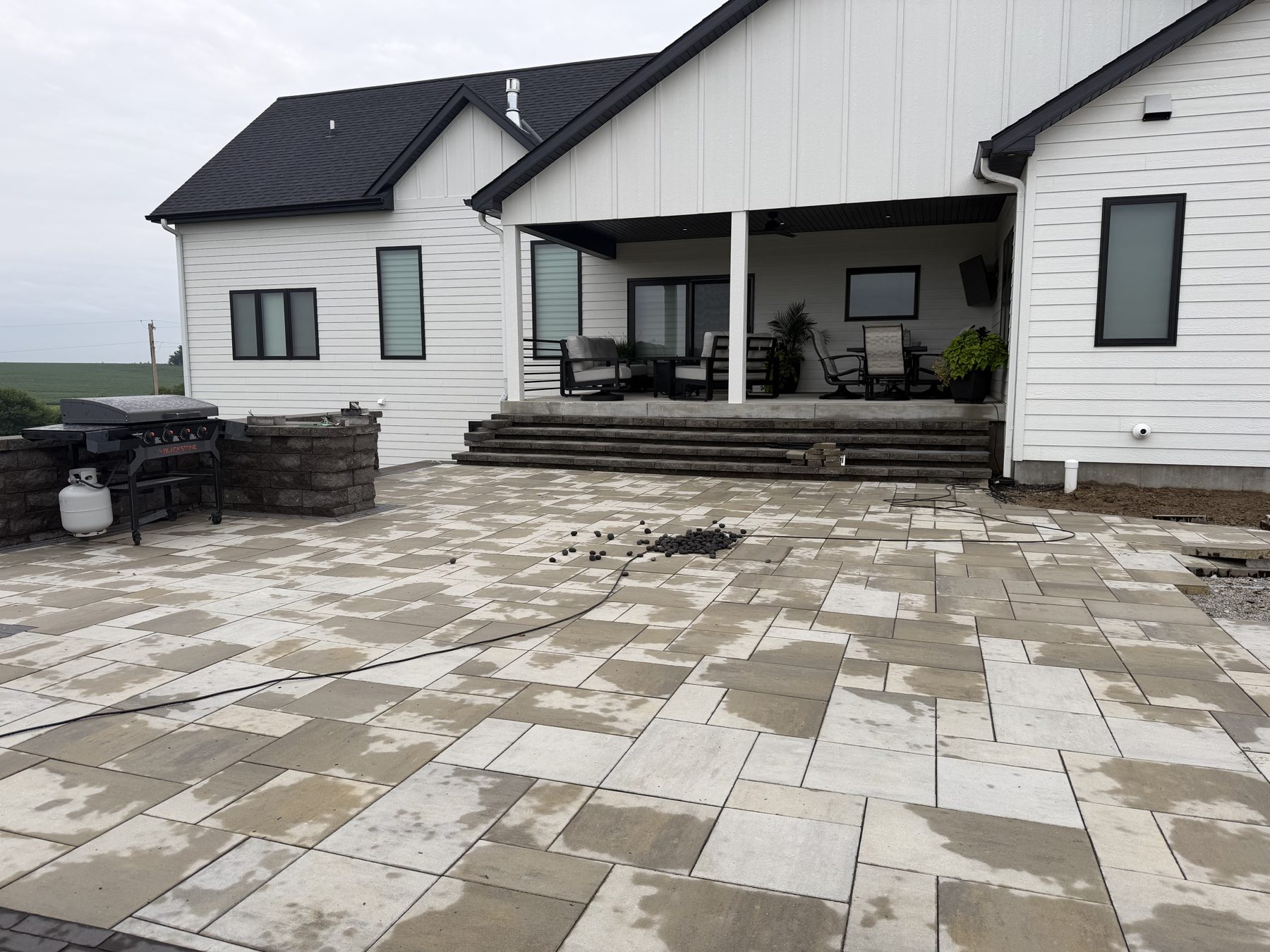 Paver patio with outdoor kitchen installation — Lincoln Creek Landscape & Design, Nebraska hardscaping contractor